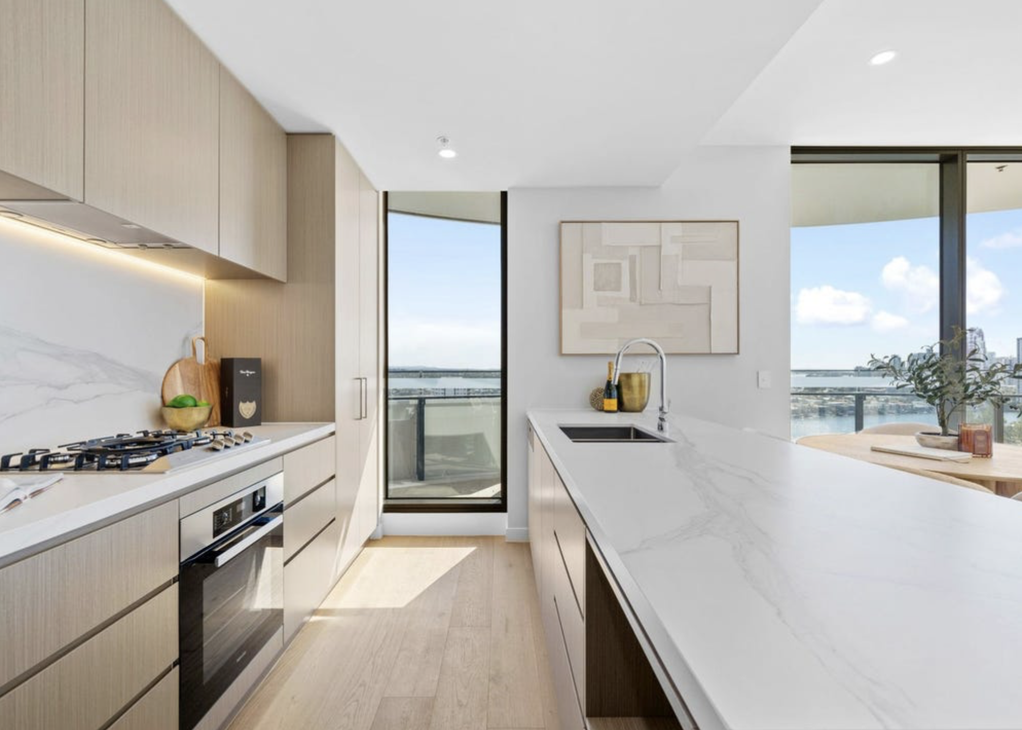 Chef-curated Miele kitchen with marble waterfall island and panoramic Gold Coast views